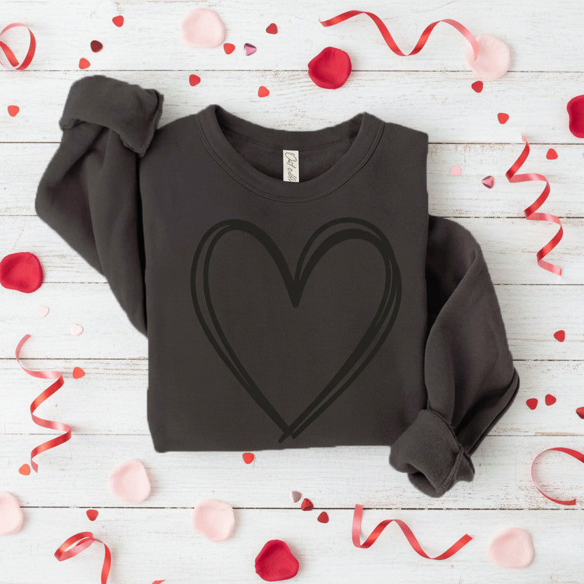 Black sweatshirt with a heart design on a wooden background