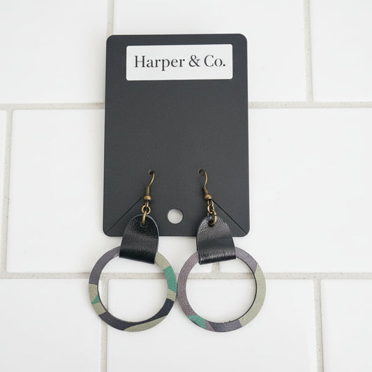 Pair of earrings on a white surface.