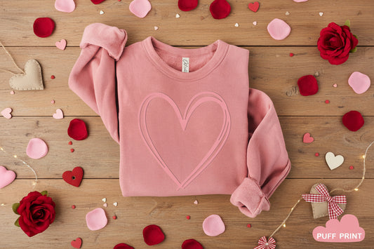 Pink sweatshirt with a heart design on a white background