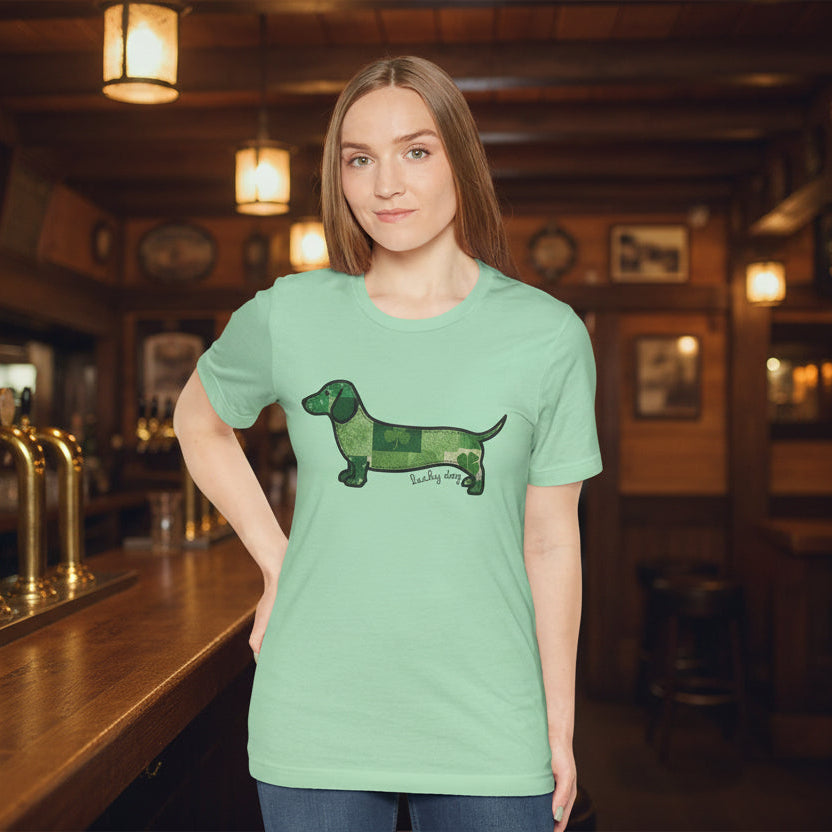 Woman wearing a light green t-shirt with a dog graphic on a white background